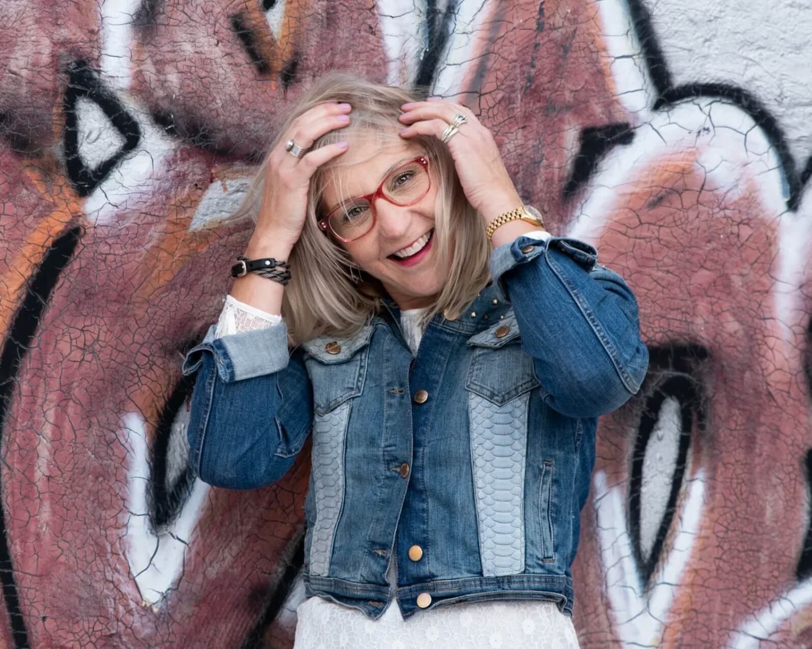 Personal stylist Kerry Cordero being a style rebel in front of a wall with some edgy street art