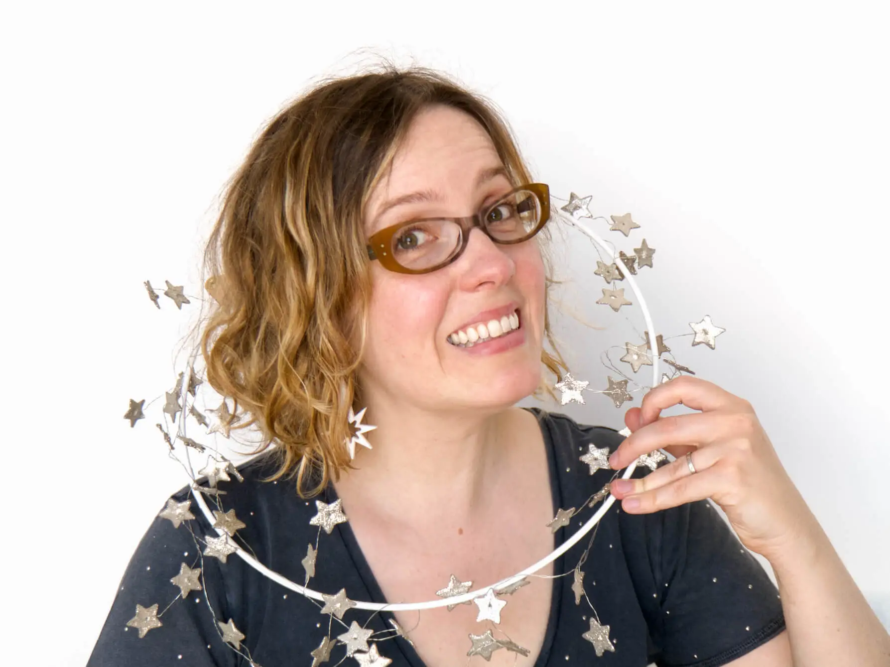 Alexandria smiling with a sparkly star wreath