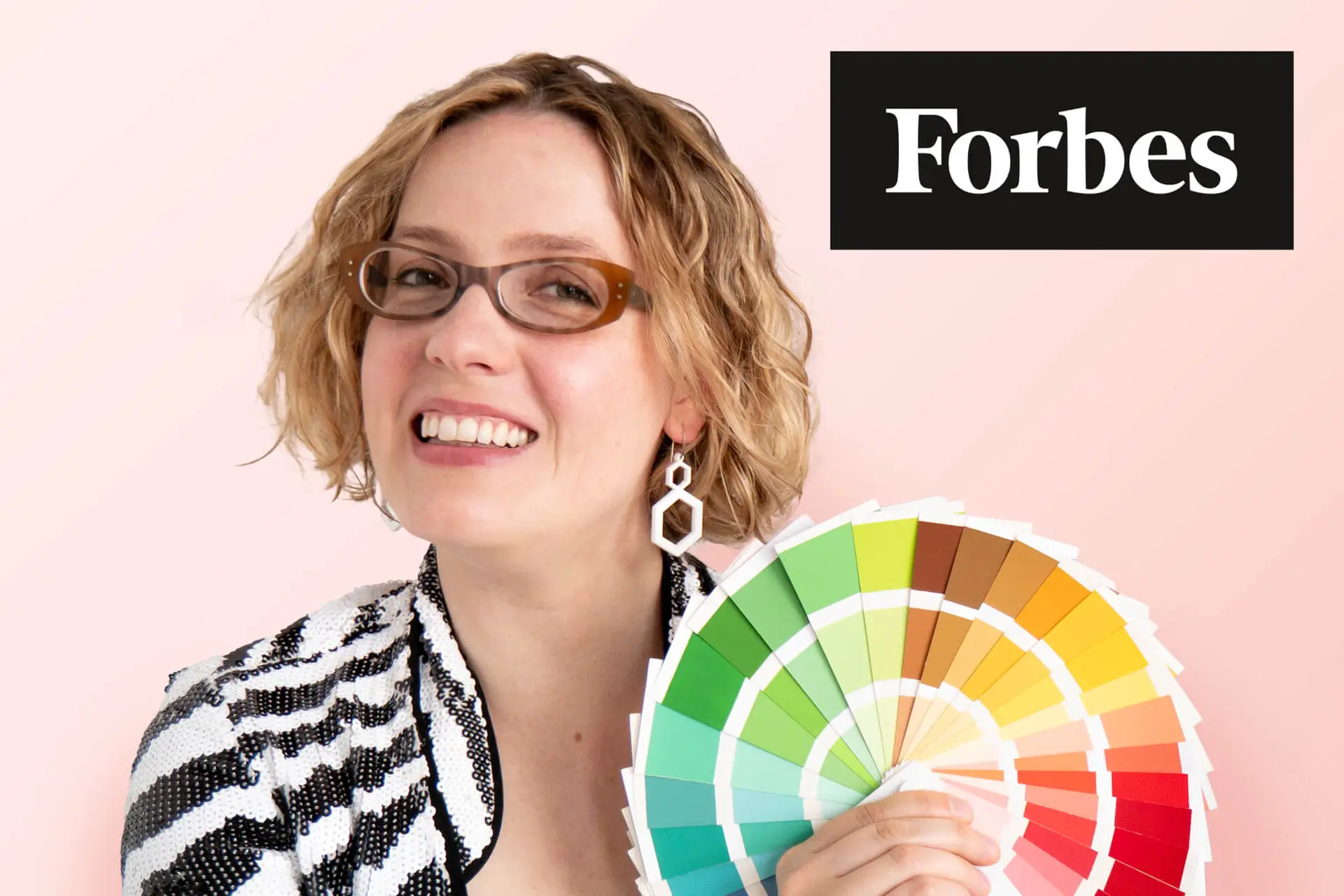 Alexandria Lawrence holding cheery spring colour fan, as featured on Forbes.